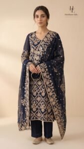 Navy blue formal by Roohèrang featuring intricate silver-gold floral embroidery on a rich sheer fabric